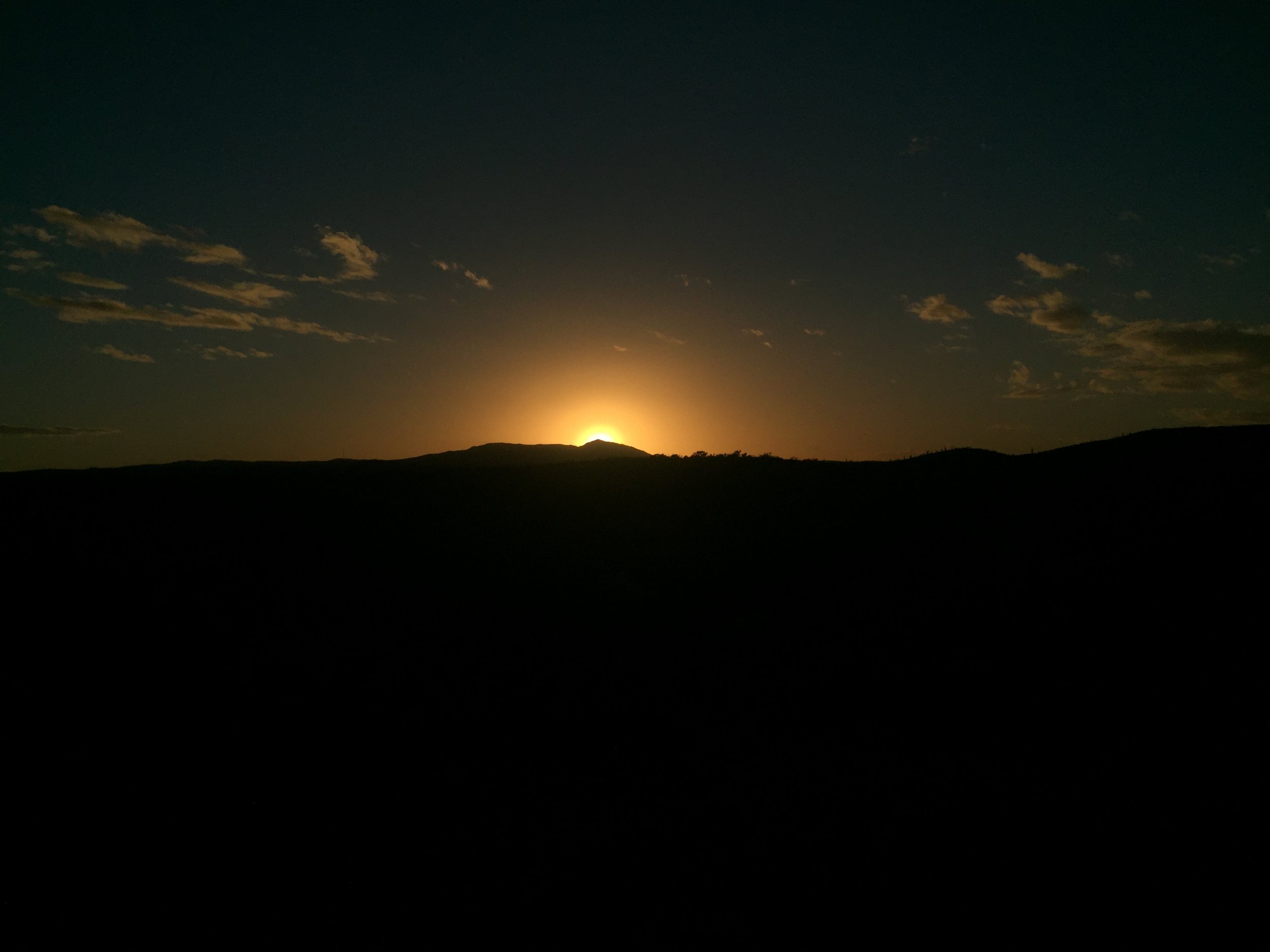 Sun setting over the desert hills
